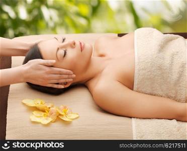 spa and holidays - woman in spa getting facial massage. woman in spa getting facial massage