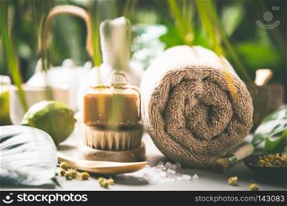 Spa and massage products on tropical leaves background