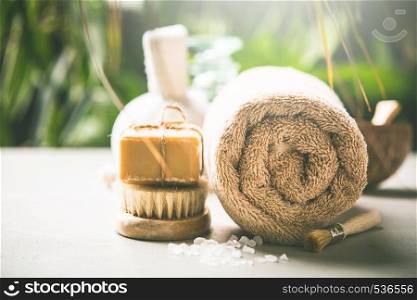 Spa and massage products on tropical leaves background. SPA composition on tropical leaves background, close up