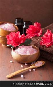 spa aromatherapy with azalea flowers and herbal salt on rustic dark background