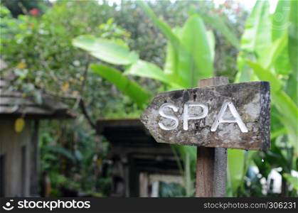 SPA arrow sign from wood on beach resort