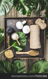 Spa background, flat lay layout with monstera leaves, vintage tray and cosmetic care products