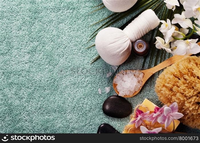 Spa background (pink orchid, herbal compress stamps, sea salt, towel and massage stones)