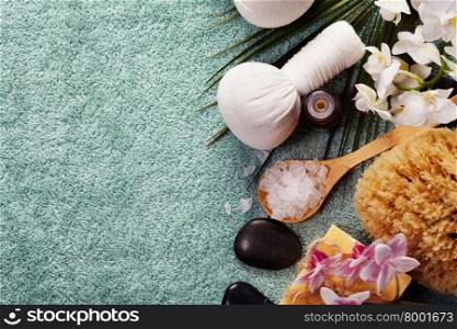 Spa background (pink orchid, herbal compress stamps, sea salt, towel and massage stones)