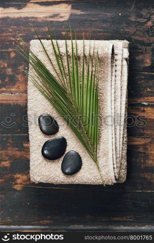 Spa background (towel, massage stones and leaf )