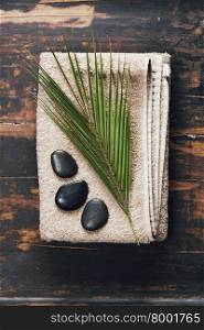 Spa background (towel, massage stones and leaf )