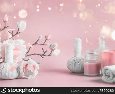 Spa background with body care tools , flowers and cosmetic at pastel pink background with blossom branches and bokeh. Beauty concept