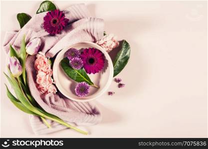 Spa background with flowers and towel. Flat lay.Space for text