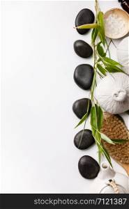 SPA background with massage compress balls, stones, sea salt, brush and teapot on white background, flat lay, space for text