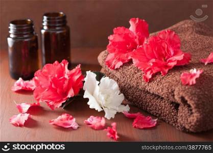spa bathroom with azalea flowers essential oil on dark rustic background