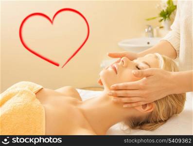 spa, beauty, resort and relaxation concept - close up of woman in spa salon getting face treatment