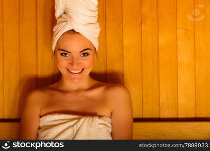 Spa beauty treatment and lifestyle relaxation concept. woman white towel relaxing in wooden sauna room.