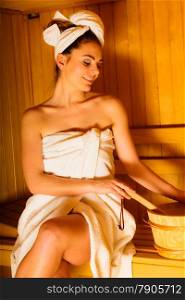 Spa beauty treatment and lifestyle relaxation concept. woman white towel relaxing in wooden sauna room.