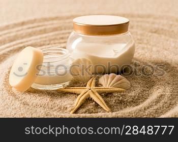 Spa body cream seashell star on sand beauty treatment