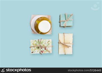 spa, bodycare and natural cosmetics concept - handmade soap bars over blue background. handmade soap bars over blue background