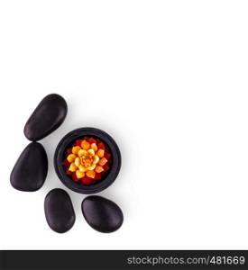 spa composition. black stones and a candle on white background