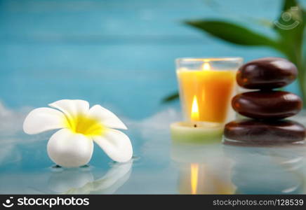 spa concept with candle, stone, flower and bamboo, relaxation