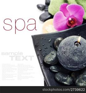 spa concept (zen stones, candle, towel and orchid) over white with sample text