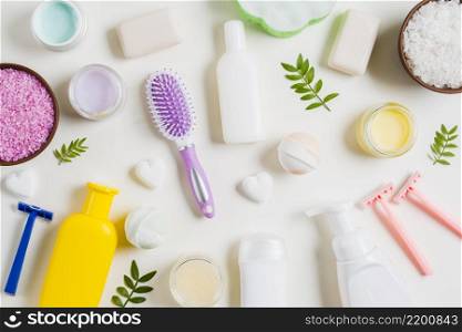 spa cosmetics products with razor hairbrush white background