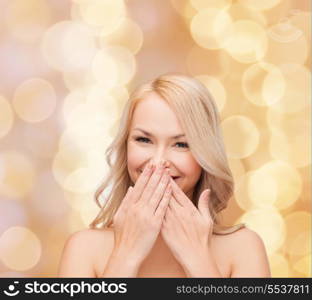 spa, health and beauty concept - beautiful woman covering her mouth