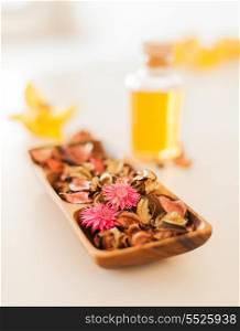 spa, health and beauty concept - closeup of essential oil, flowers and pot-pourri