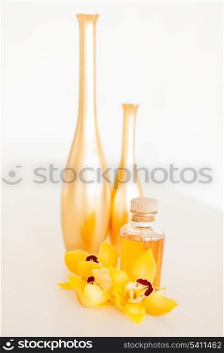 spa, health and beauty concept - closeup of vase, flowers and oil