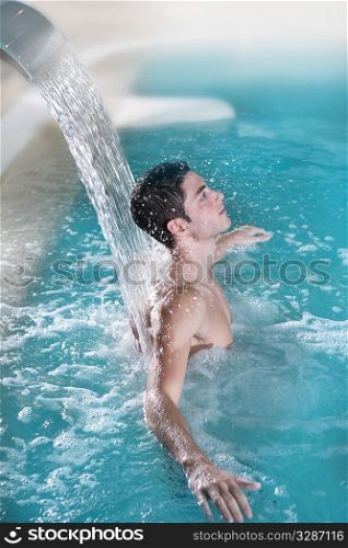 spa hydrotherapy man waterfall jet turquoise swimming pool water