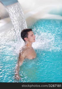 spa hydrotherapy man waterfall jet turquoise swimming pool water