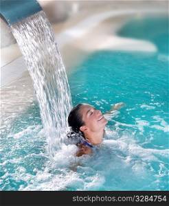 spa hydrotherapy woman waterfall jet turquoise swimming pool water