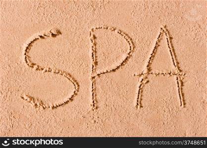 Spa is written in the sand on the beach in large letters