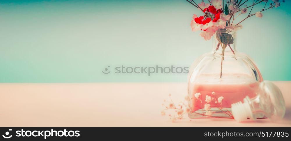Spa or wellness background with room fragrance bottle and flowers on pastel background, front view, banner
