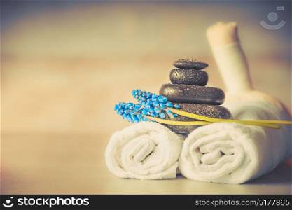 Spa or wellness setting with massage equipment and flowers and herbal balls