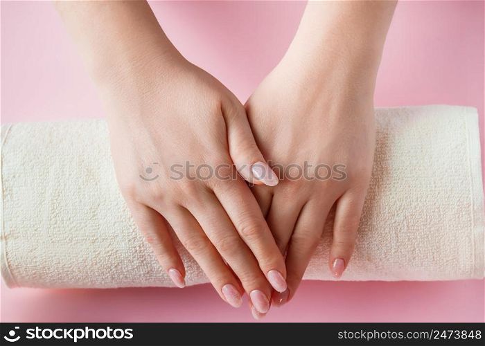 Spa procedure for nail care in a beauty salon. Female hands and tools for manicure on a pink background. Bodycare concept.. Spa procedure for nail care in a beauty salon. Female hands and tools for manicure on pink background. Bodycare concept.