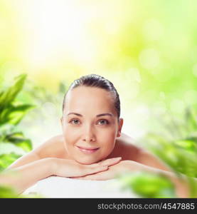 Spa procedure. Image of young woman relaxing in spa salon