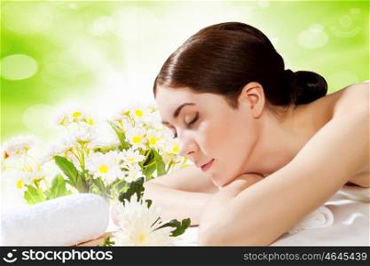 Spa procedure. Image of young woman relaxing in spa salon
