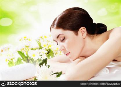 Spa procedure. Image of young woman relaxing in spa salon