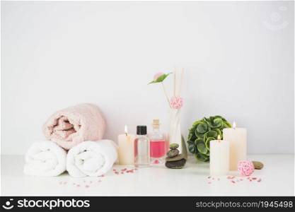 spa products illuminated candles white tabletop. High resolution photo. spa products illuminated candles white tabletop. High quality photo
