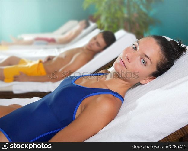 spa relax room hammock row beautiful girl and men in background