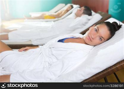 spa relax room hammock row beautiful girl and men in background