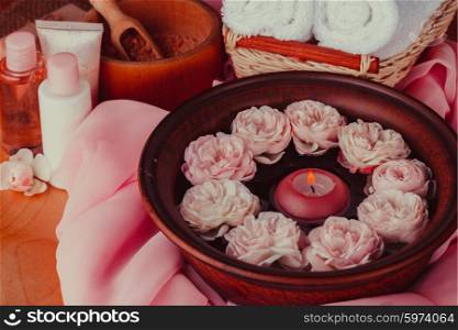 Spa relaxation - burned candle floating in rose water. Spa relaxation