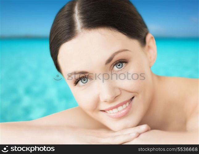 spa, resort and vacation concept - smiling woman lying on the beach