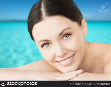 spa, resort and vacation concept - smiling woman lying on the beach