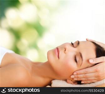 spa, resort, beauty and health concept - beautiful woman in spa salon getting face treatment