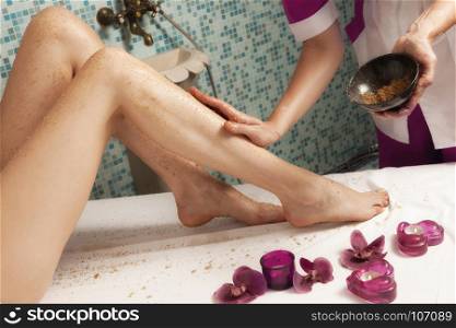 Spa salon: Beautiful Young Woman having Depilation on Legs with Sugar