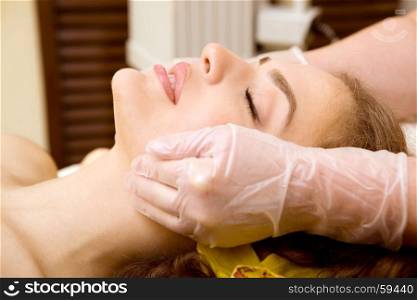 Spa salon: Beautiful Young Woman having Facial Treatment in Spa salon