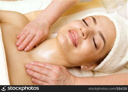 Spa salon: Beautiful Young Woman having Facial Treatment in Spa salon with Oil