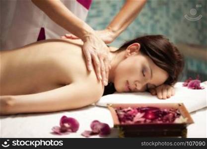 Spa salon: Beautiful Young Woman with Long Hair having Hand Massage in Spa salon.