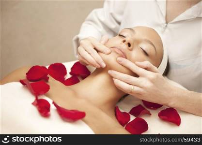 Spa salon: Young Beautiful Woman Having Facial Massage