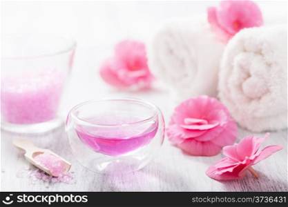 spa set with begonia flowers and essential oil