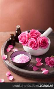 spa set with rose flowers mortar essential oils salt